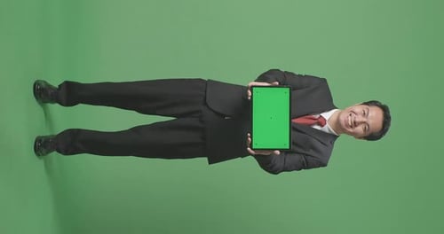 Full Body Of Asian Business Man Showing Tablet Green Screen On Green Screen Background In The Studio