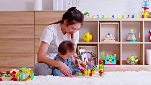 Mother and Baby Play Together with Toys at Home