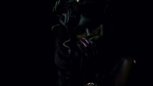 Medusa with Snake Hair Posing in Dark Studio
