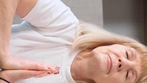 Senior Woman Meditating Indoors in Close Up