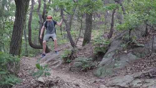Male Hiker climbs down A Rocky Mountain With Narrow Path - Medium Shot, hiking concept