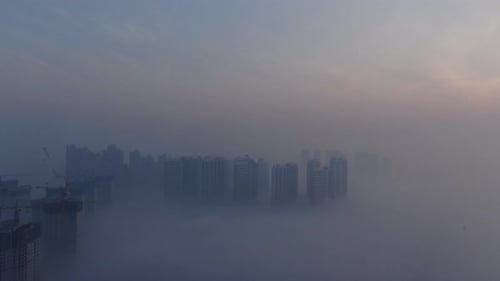 A city that seems to be floating in the air with fog and dust.