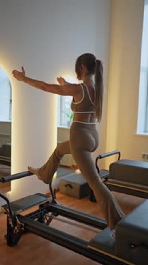 Woman Working Out on Pilates Machine in Studio