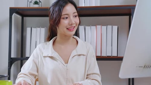 Portrait young asian businesswoman taking a break after overworked with stretching arm and hand.