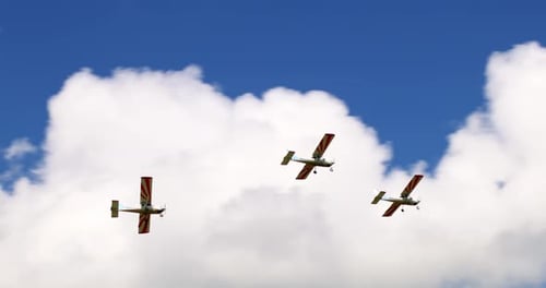 Planes Flying Formation in Blue Cloudy Sky