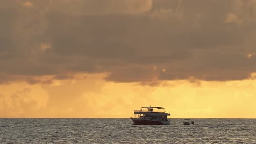 Boat Sailing the Sea at Sunrise or Sunset