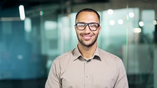 Smiling Man Wearing Glasses in Office