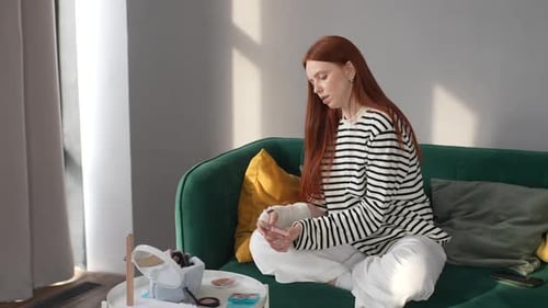Young Woman Applying Makeup at Home