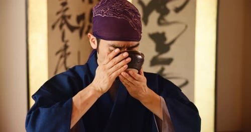 Man Drinking from Bowl, Eyes Closed