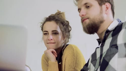 Young Couple Working Together in an Office