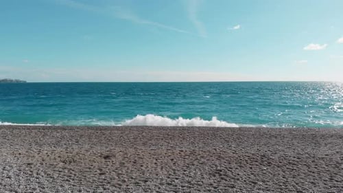The Camera Flies Low Over the Beach Towards the Sea and Flies Into the Open Sea