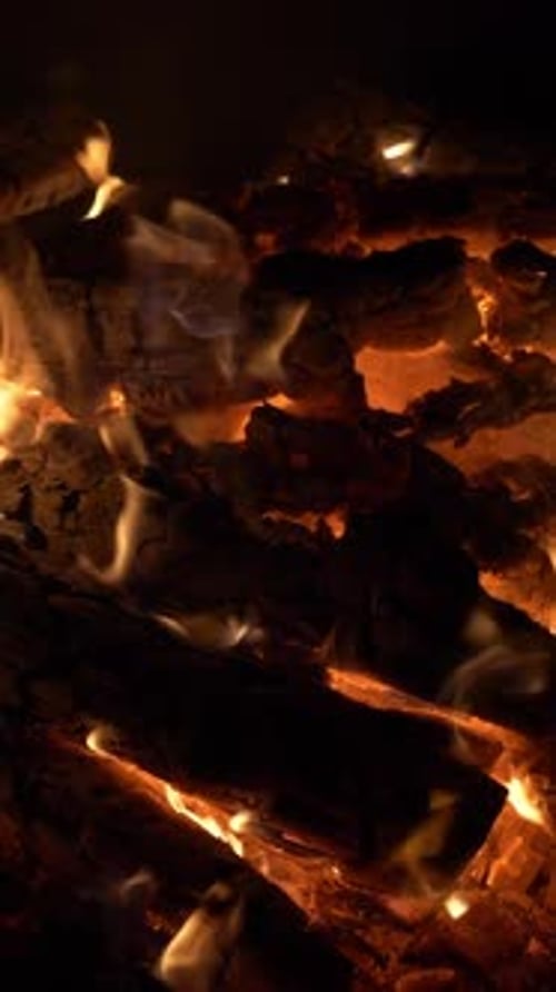 Burning Firewood Close Up in a Dark Fireplace