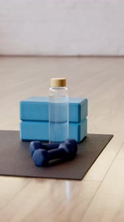 Yoga, empty and dumbbells in studio on floor for workout routine, exercise and fitness class