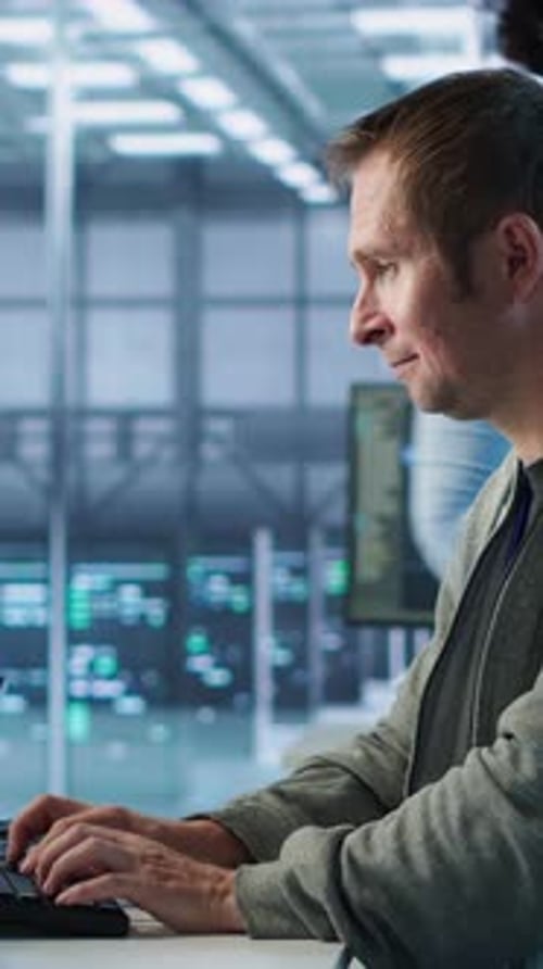 Man Working in Server Hub Capable of Processing Vast Amounts of Data