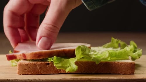 Making a Sandwich with Meat and Lettuce
