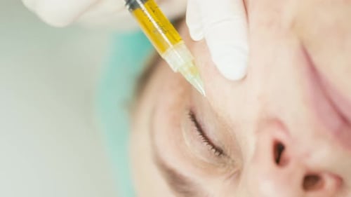 Woman Receives Cosmetic Injection in Doctor's Office