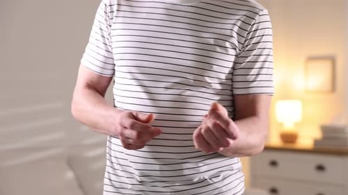 Man snapping fingers and dancing at home, closeup