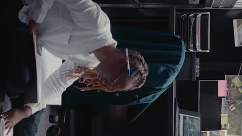 Worker in Office with Blond Hair Completes Paperwork