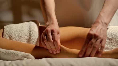 Woman receiving relaxing arm massage on massage table