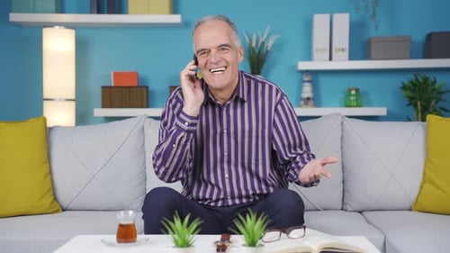 Senior Man Talking on Phone at Home