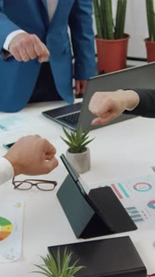 Teamwork: Business People Fist Bumping Over Desk