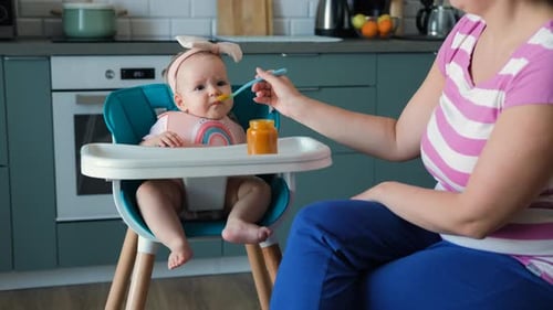 Infant Feeding in Kitchen with Caregiver