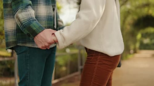 Close-up of young couple holding hands