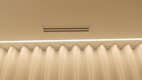 Elegant Pleated Curtain with Warm Interior Lighting