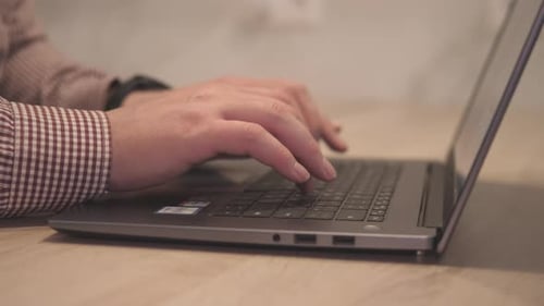 Hands Typing on a Laptop Keyboard Close Up