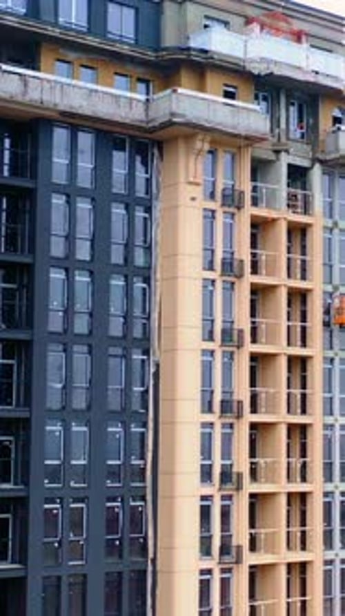 Construction of modern tower building. Exterior of a new architecture in the city.