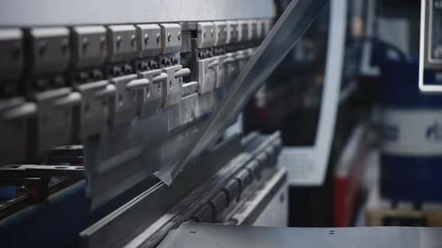 The Process of Bending Steel Sheet in Production A Worker Makes Parts with a Machine Tool and a