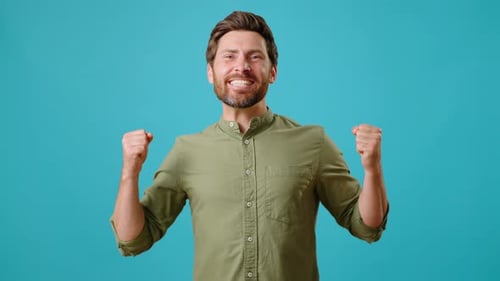 Excited Man Pumping Fists on Blue Background