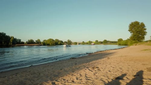 Steady gimbal shot of the boat passing at the river on a sunny day in the Netherlands