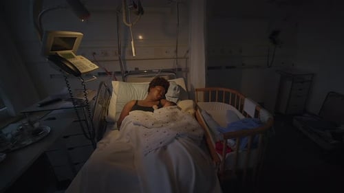 A Mother and Her Newborn Baby Bonding Peacefully in a Hospital Room with Gentle Lighting