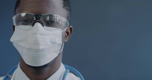 Doctor Wearing Safety Glasses and Mask Close Up
