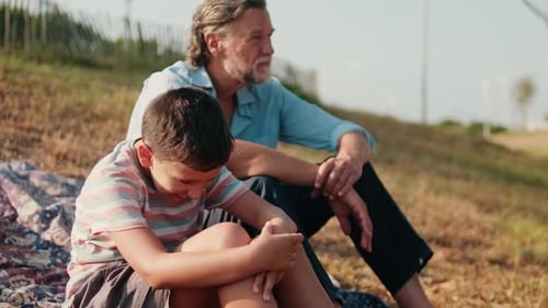 Grandfather and Grandson Spend Time Together Outdoors
