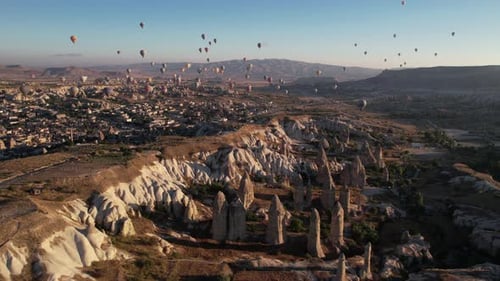 Cappadocia Turkey on Sunny Morning, Hot Air Balloons Flying Above Scenic Landscape, Drone Aerial Vie