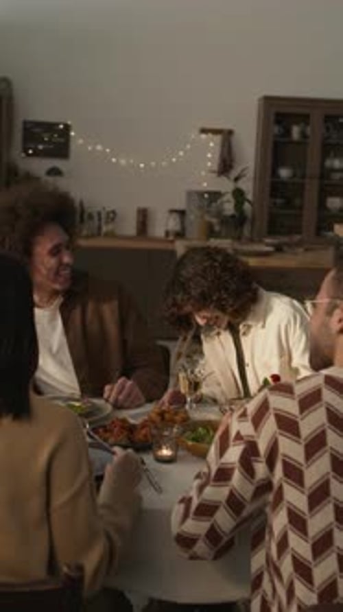 Friends Gathering Around Table to Eat and Toast