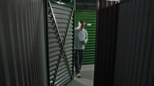 Father and Son Loading Boxes inside Self Storage Unit