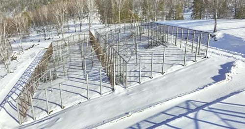 Aerial shot of outdoor enclosure in snowy landscape