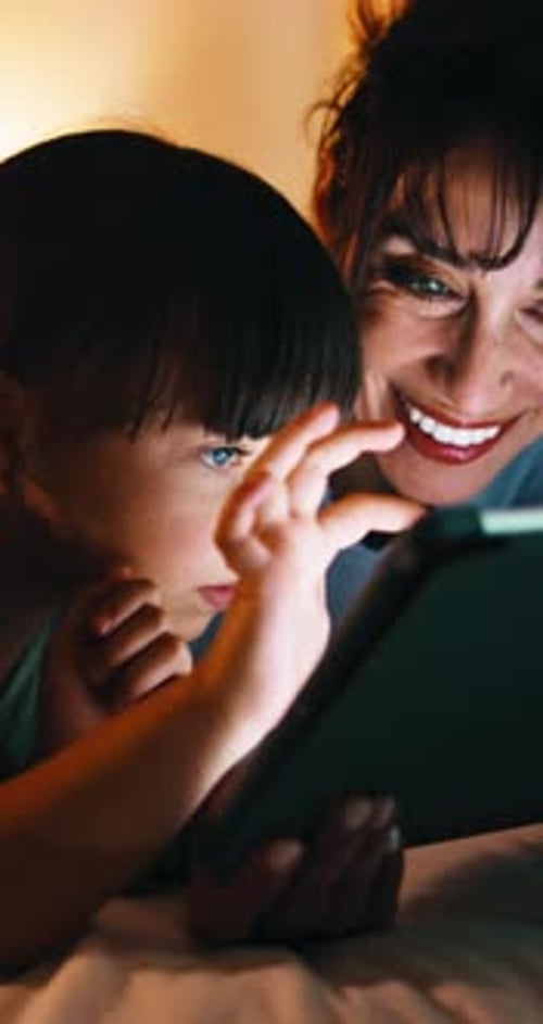 Night, mom and girl in bedroom with tablet for online streaming, internet or cartoons together