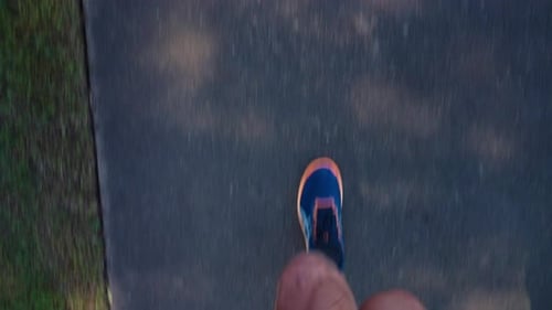 First Person View Of Mens Running Shoes Jogging On Outdoor Pavement In 4K Slow Motion