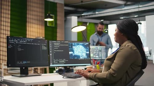 Woman Coding at Desk in Modern Office