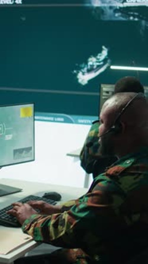 Vertical Video Military Personnel in Base of Operations Using Advanced Computers and Big Screen