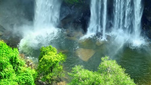 Aerial view over a waterfall in a beautiful tropical forest.