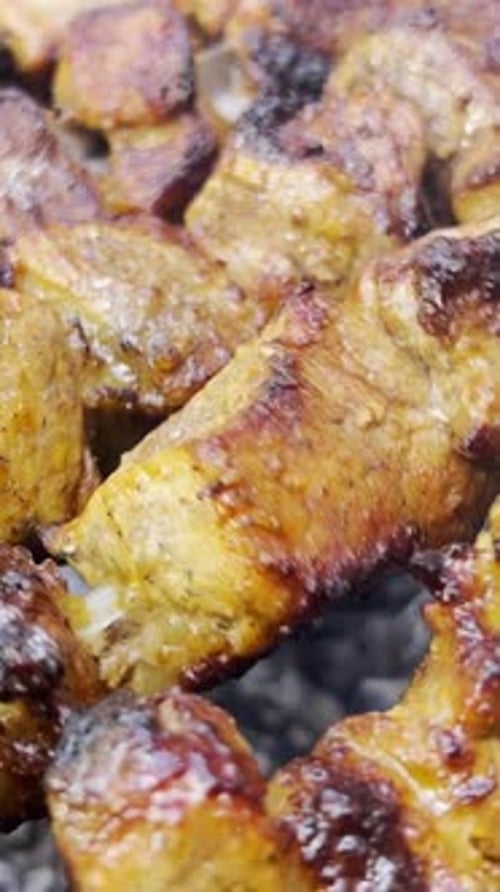 Grilled Meat Cubes Sizzle in Close Up Vertical Shot