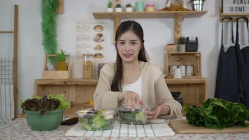 Woman Prepares Healthy Salad at Kitchen Table