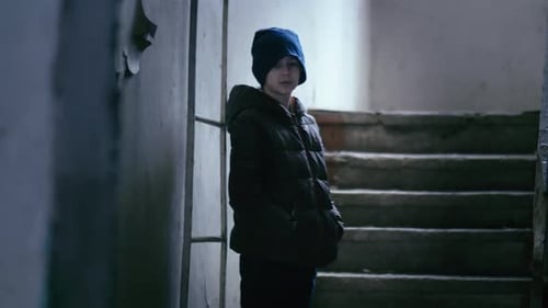 Playful Boy's Exploration Seeking Hideout in Abandoned Building While Wiping His Nose