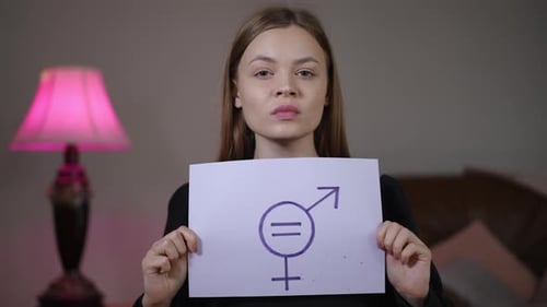 Female Student Displaying Gender Equality Symbol with Determination