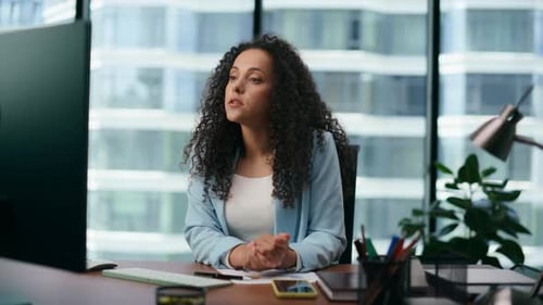 Serious Woman Executive Director Reporting Online Using Computer Camera Close Up. Latin Businessw...